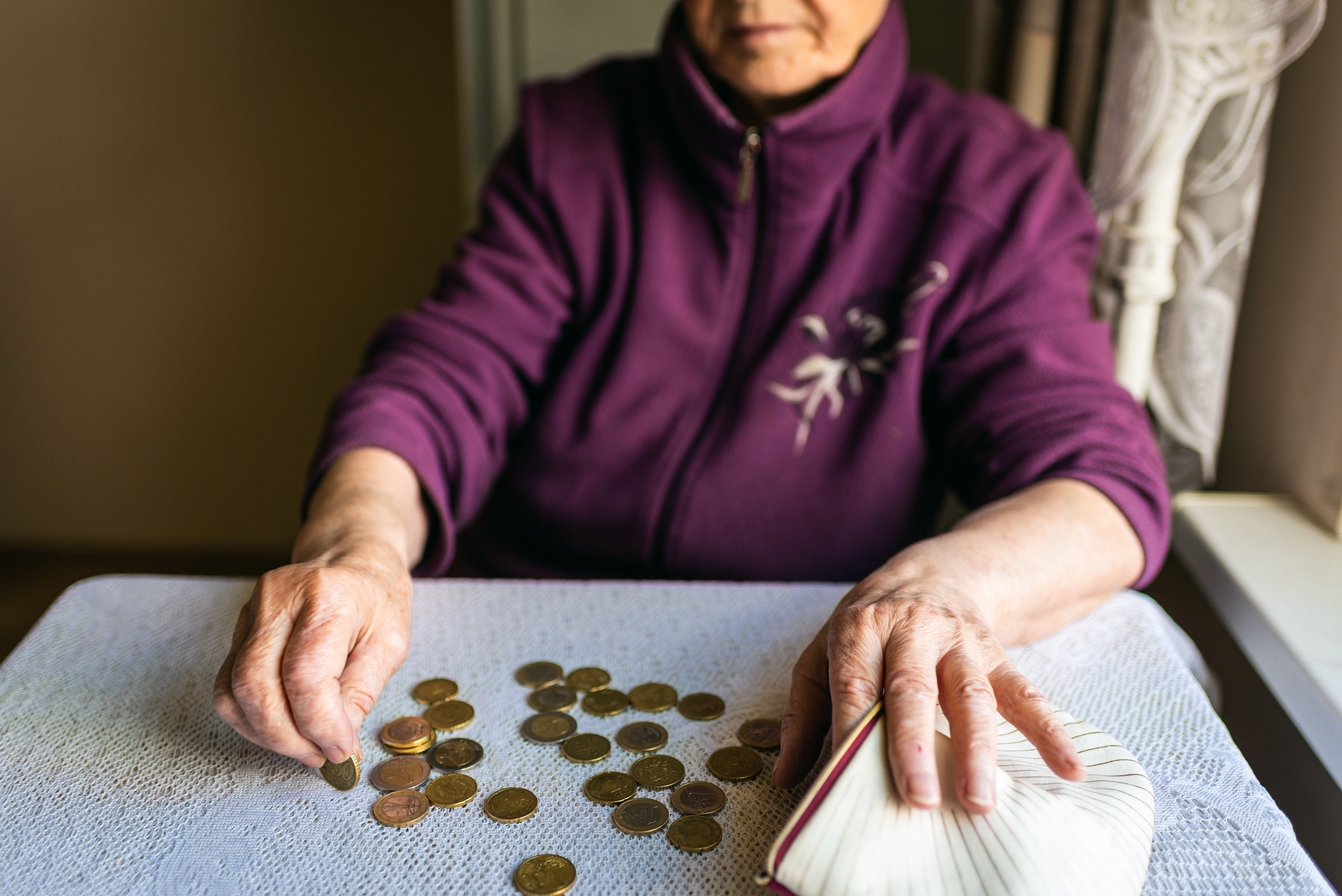 retired worried woman counting pennies